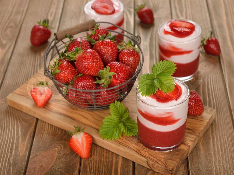 Dessert with strawberry jelly and whipped cream on a brown background, stock photo