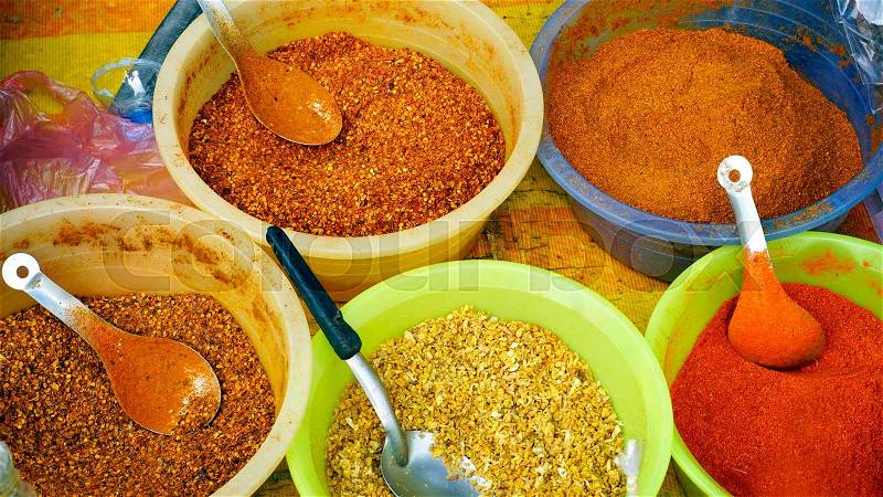 Colorful chili powder and spice in the bucket at fresh local market in Luang Prabang, Laos, stock photo