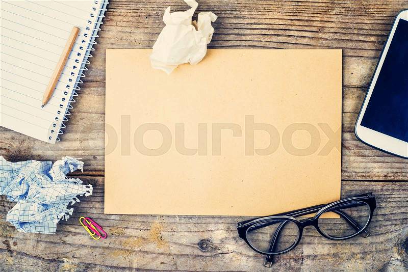 Desktop mix on a wooden office table background. View from above, stock photo