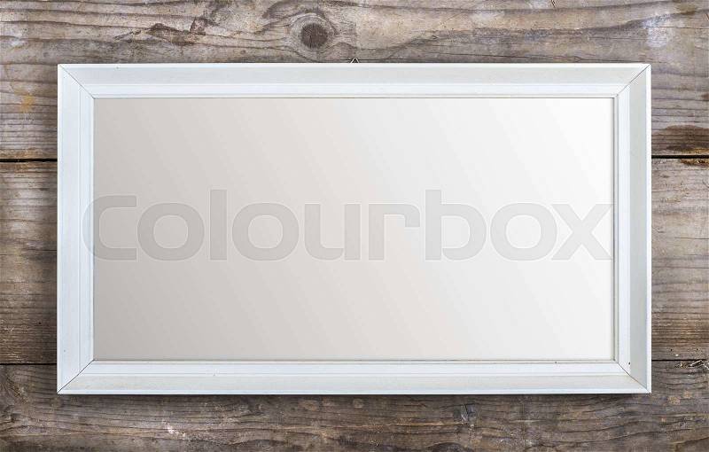 Rectangle picture frame laid on wooden floor backround, stock photo