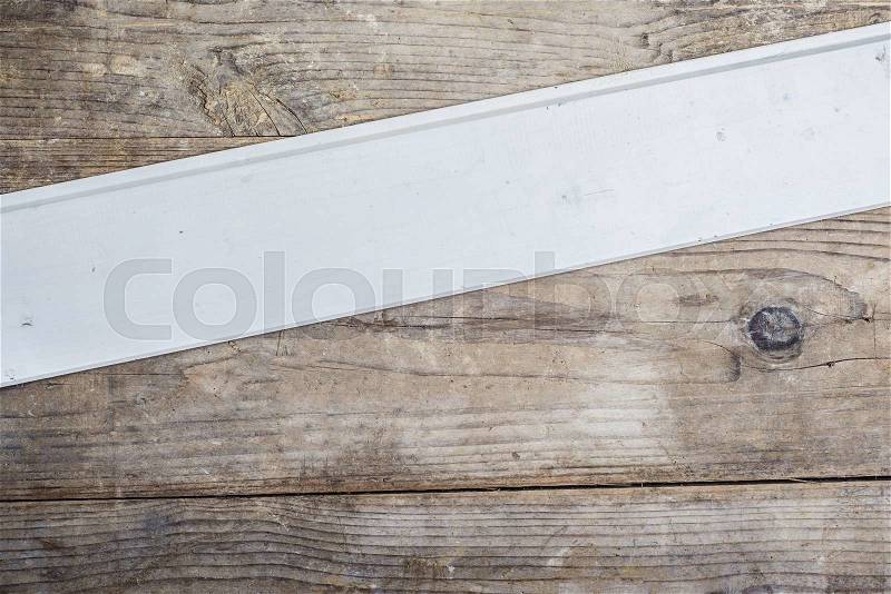 Board with texture laid on wooden floor background, stock photo