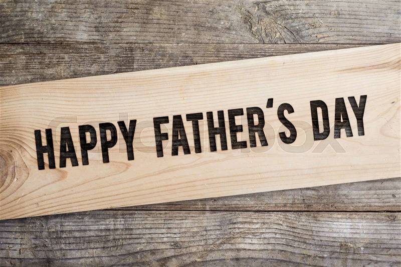 Happy fathers day sign on wooden boards background, stock photo