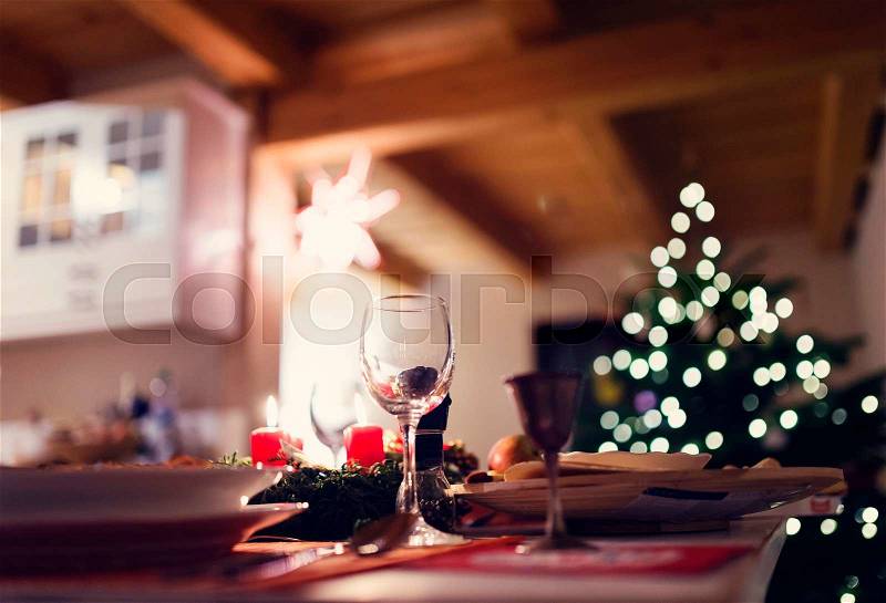 Christmas meal laid on a table in a decorated living room, stock photo