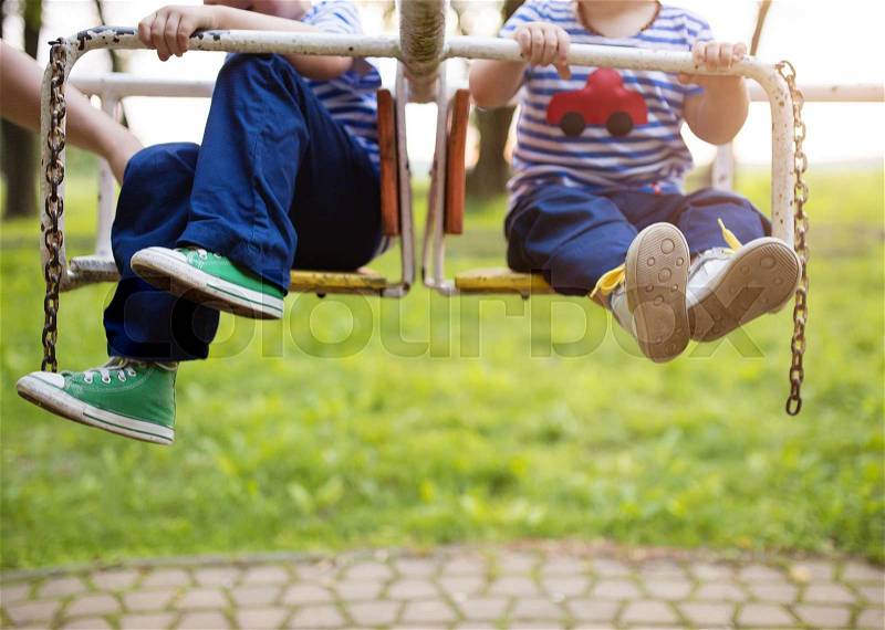 Two cute little boys on an old carousel, stock photo