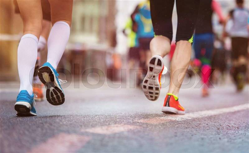 Unrecognizable young runners at the city race, stock photo