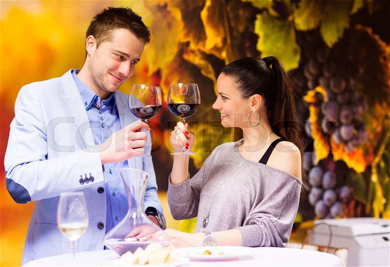 Beautiful young couple enjoying a drink in bar, stock photo