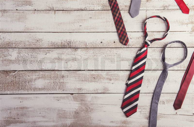 Fathers day composition of various colorful ties laid on wooden floor background, stock photo