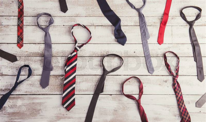 Fathers day composition of colorful ties and bow ties laid on wooden floor background, stock photo