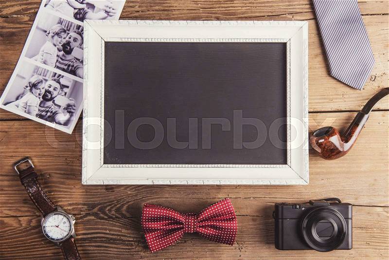 Picture frame, instant photos and various objects on wooden background, stock photo