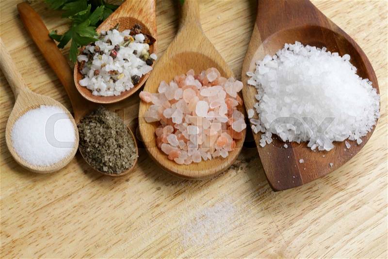Different types of salt (pink, sea, black, and with spices), stock photo