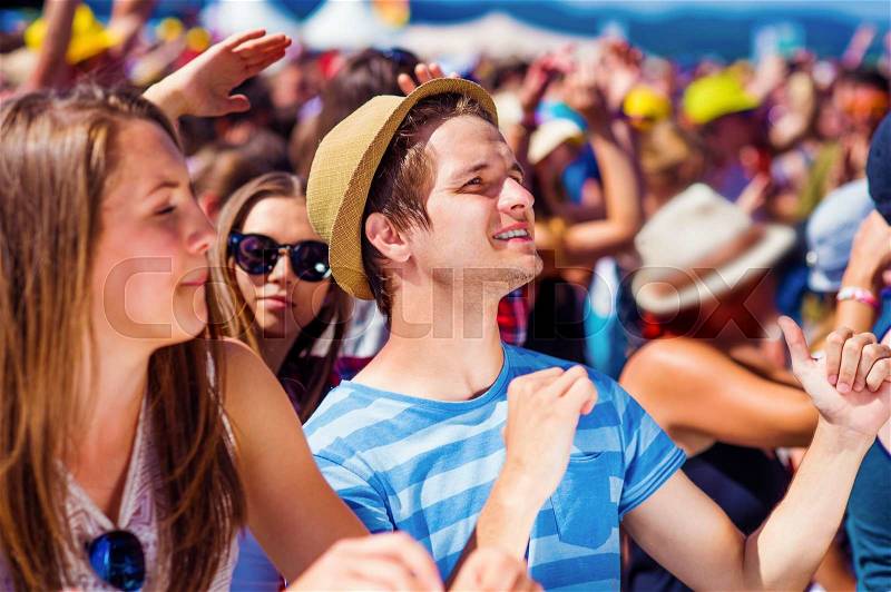 Group of beautiful teens at concert at summer festival, stock photo