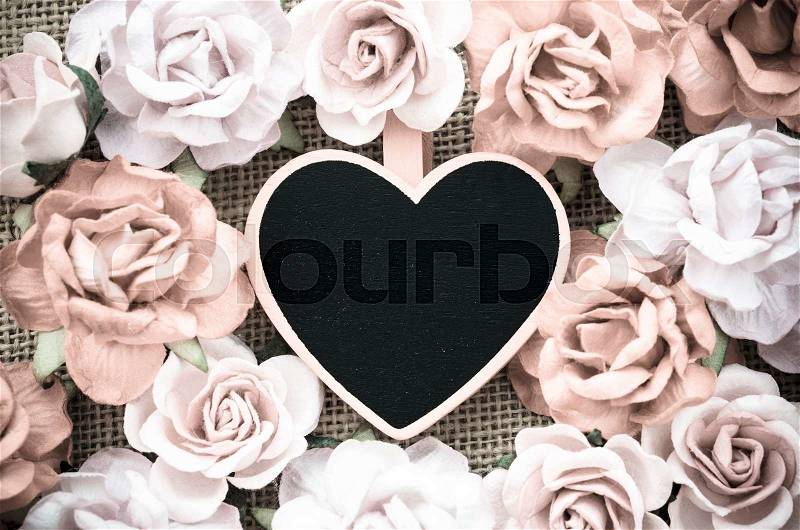 All you need is love wooden tag with roses on sack background vintage style, stock photo
