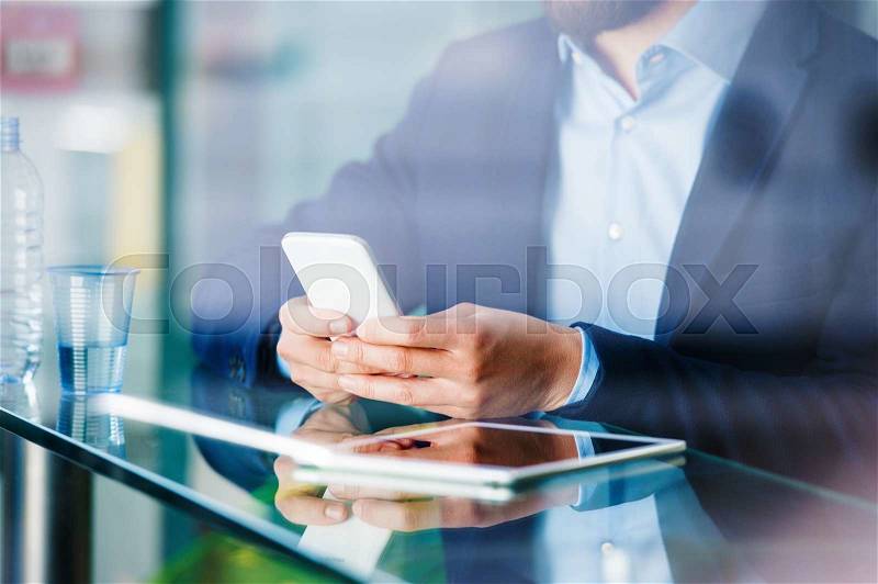 Double exposure of a handsome young man with smart phone, stock photo
