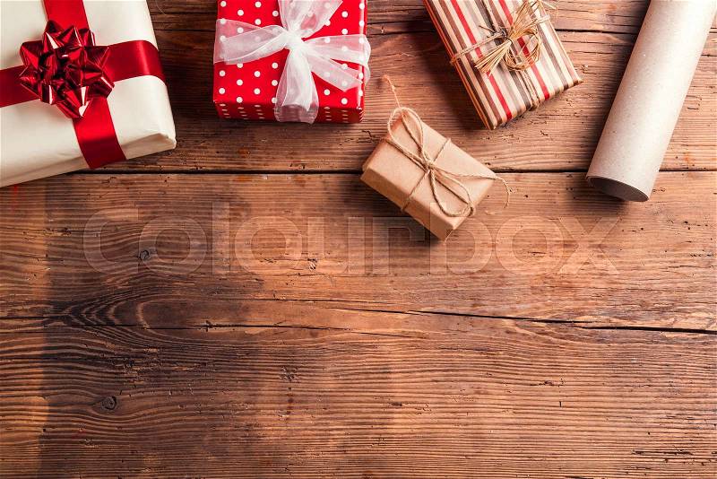 Christmas presents laid on a wooden table background, stock photo