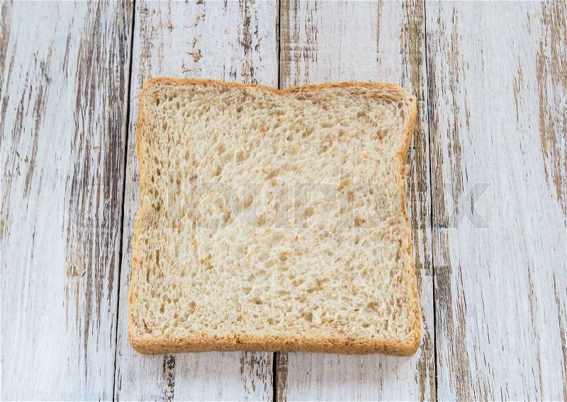 Whole wheat bread on white wooden background,meal or breakfast, stock photo