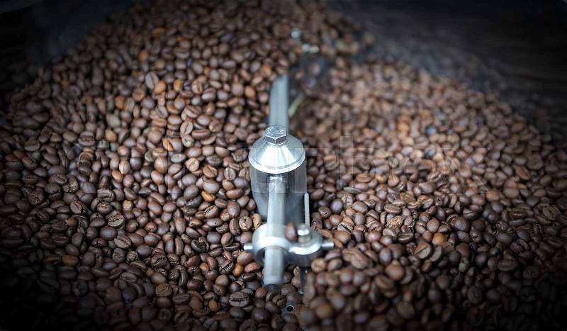 Freshly roasted coffee beans in a coffee roaster, stock photo