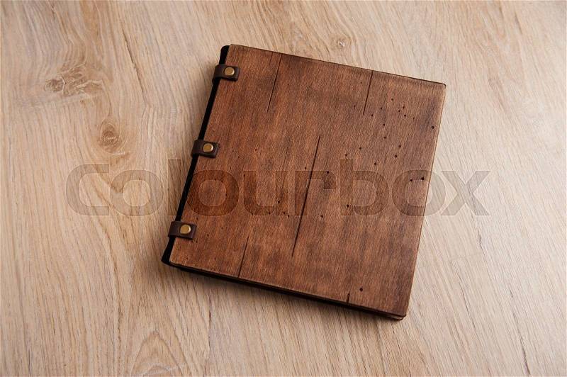 Wedding book with a wooden cover on a wooden texture, stock photo