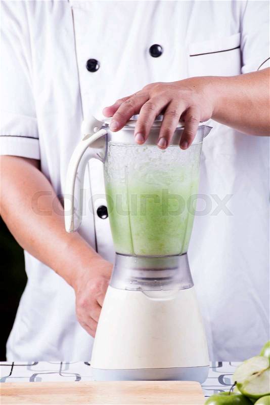 Chef making Green Apple smoothie with blender, stock photo