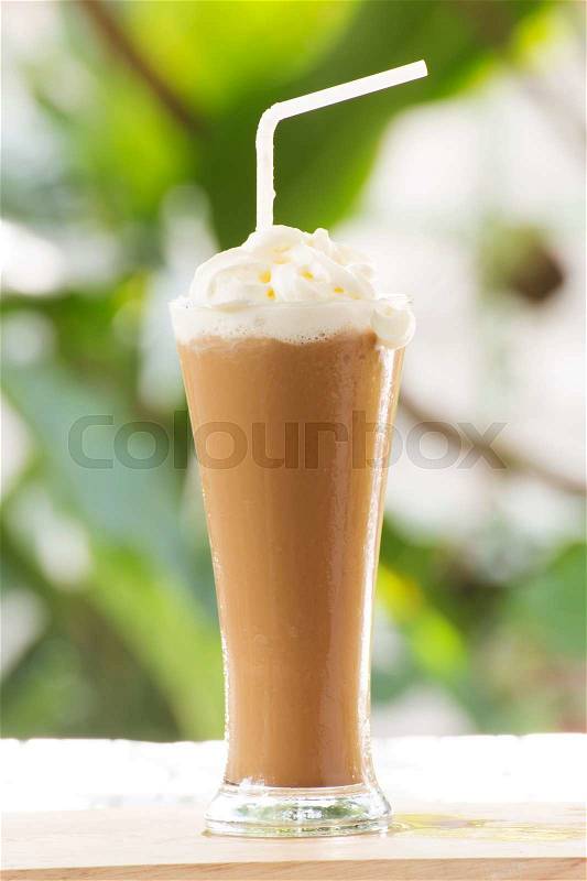 Glass of Thai Coffee smoothie topping with whip cream, stock photo