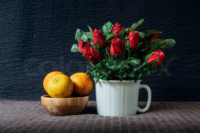 Still life with a bouquet of rose and orange. Autumn still life, stock photo