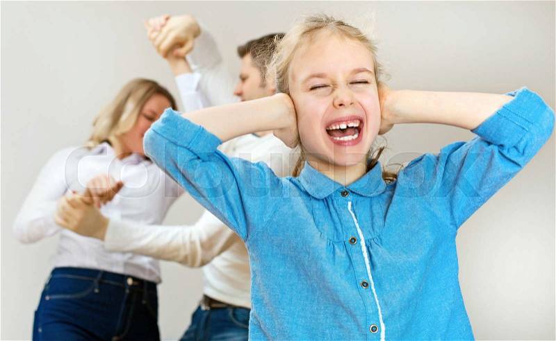 Parents quarreling at home, child is screaming, stock photo
