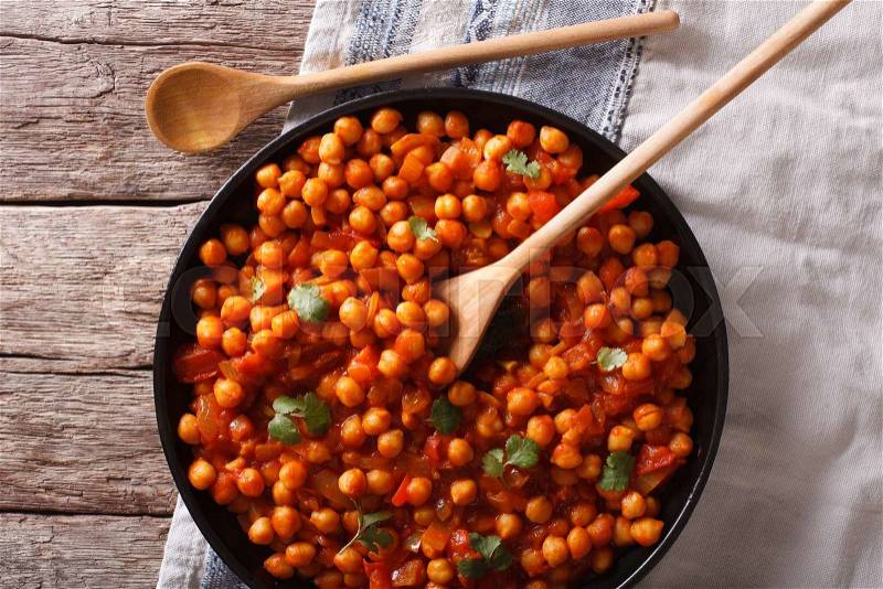 Indian Food Chana masala on a plate close-up on the table. Horizontal top view , stock photo