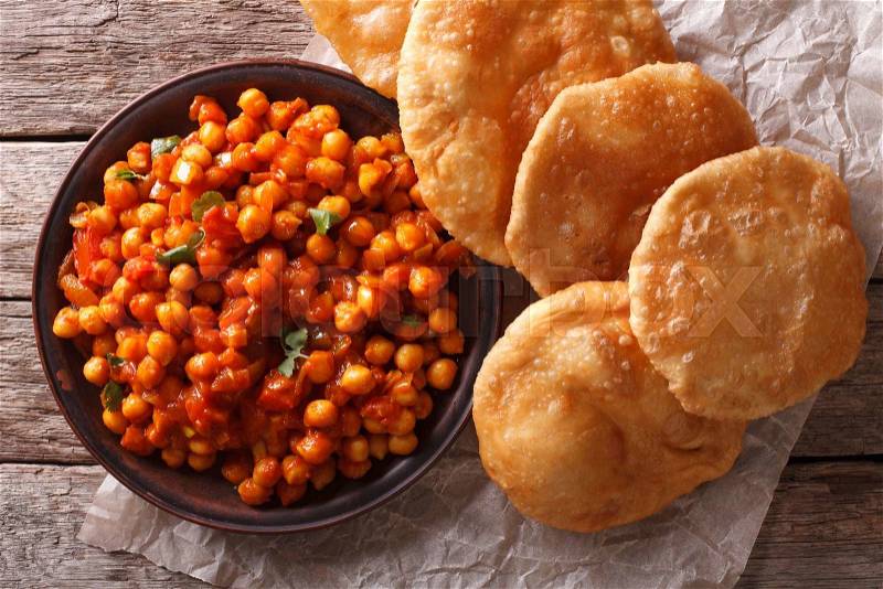 Delicious Indian Chana masala and puri bread close-up on the table. Horizontal top view , stock photo