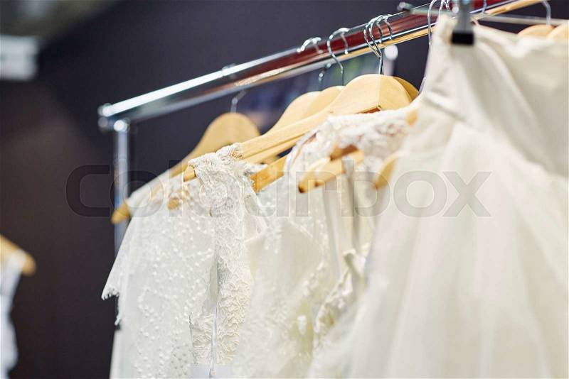 Collection of elegant wedding dresses in the shop, stock photo
