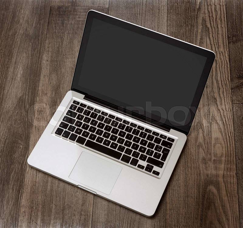 View of a Laptop in high definition on a wood background, stock photo