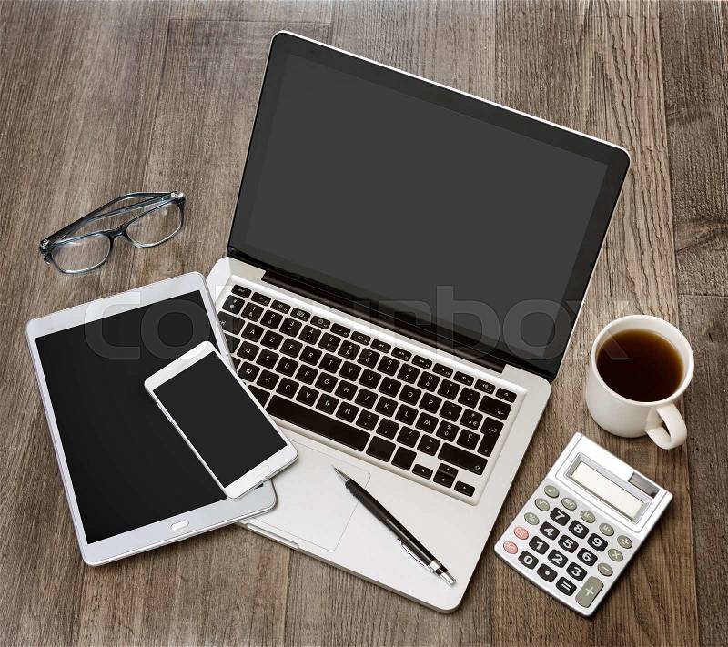 View of a Wood businessman\'s desk in high definition with laptop, tablet and mobile , stock photo