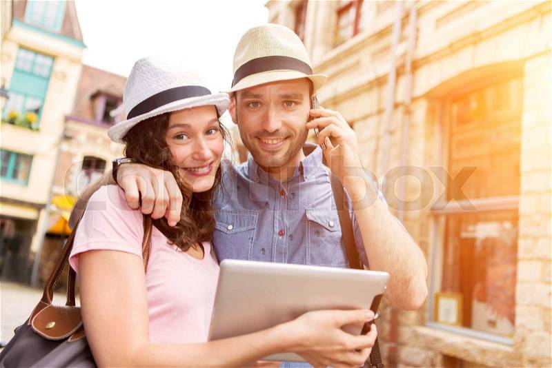View of a Couple of young attractive tourists discovering city on holidays, stock photo