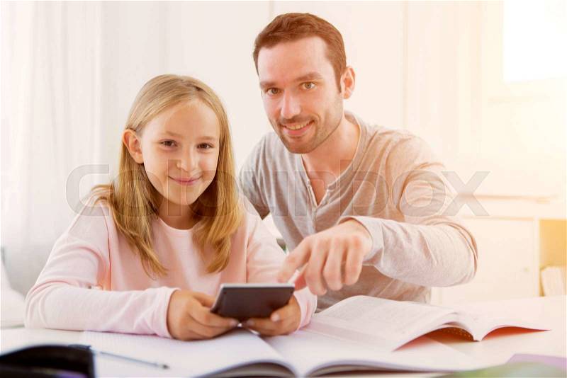 VIew ofa Father helping out her daughter for homework, stock photo