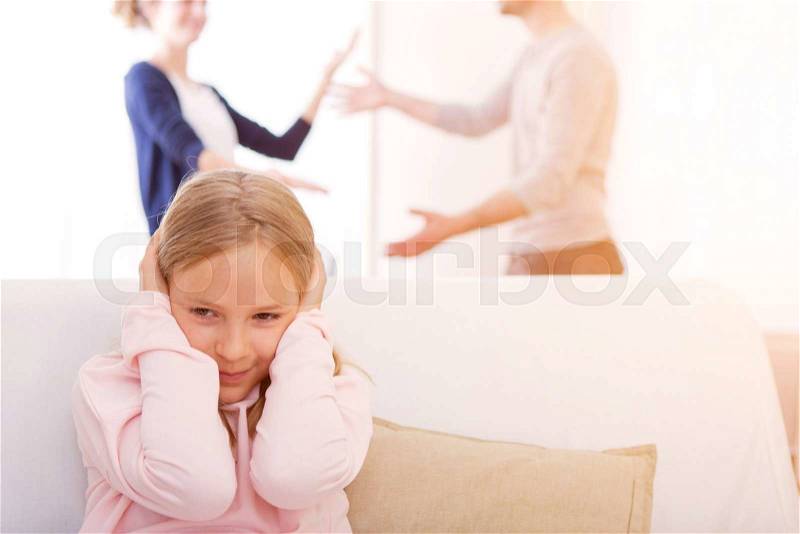 View of a Young child blocked up her ears while arguing, stock photo