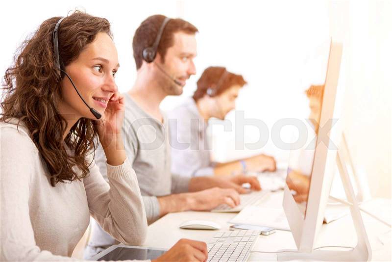 View of a Young attractive woman working in a call center, stock photo