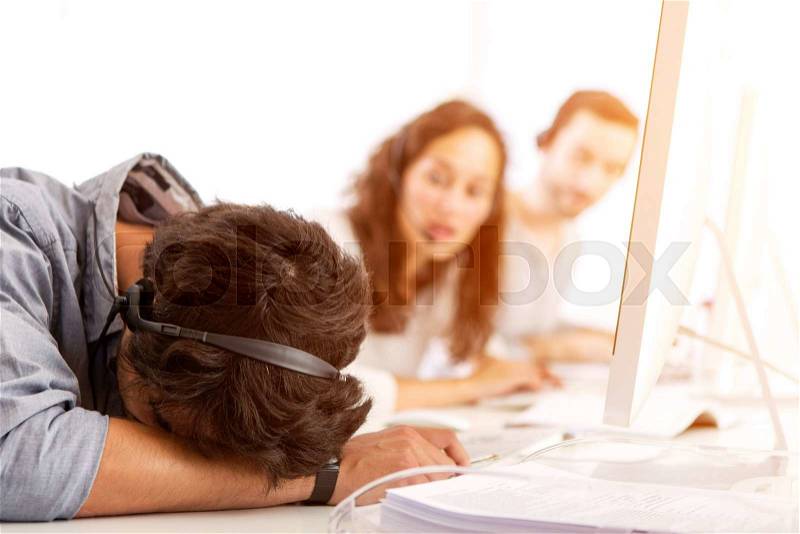 View of a Young attractive man ill-at-ease at work, stock photo