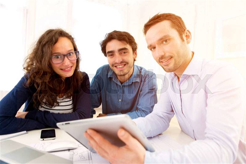 View of a young serious couple meeting a real estate agent, stock photo
