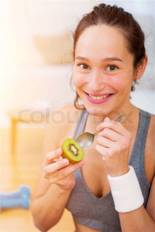 View of a Attractive sportive woman eating after sport, stock photo