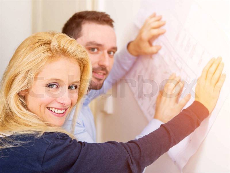 View of a Young couple studying plans of their future house, stock photo