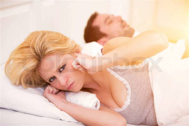 View of a Young woman can\'t sleep because of boyfriend\'s snoring, stock photo