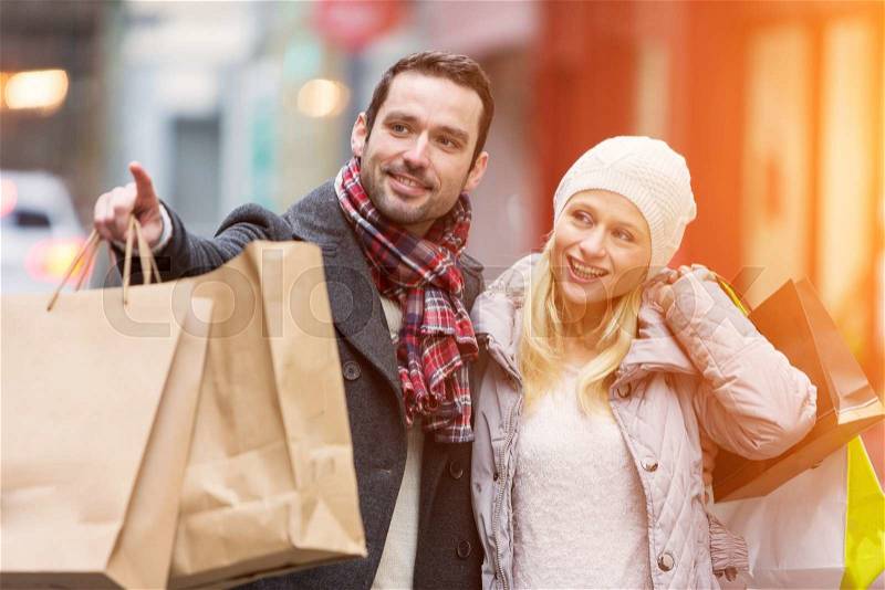 View of a Young attractive couple with shopping bags, stock photo