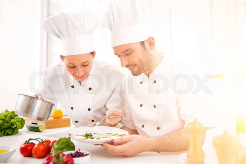 View of a Young attractives professionals chefs cooking together, stock photo