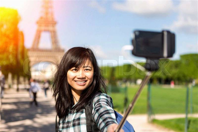 View of a Young attractive asian tourist in Paris taking selfie, stock photo