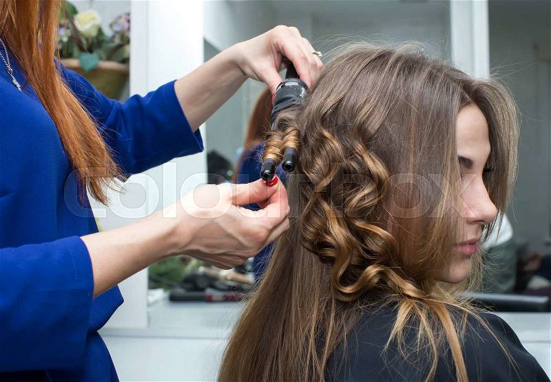 Woman in a beauty salon doing hair, stock photo