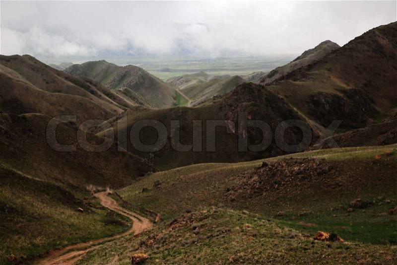 Rural road in desert mountain, stock photo