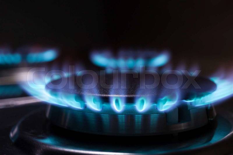 Gas burning in the burner of gas oven, stock photo