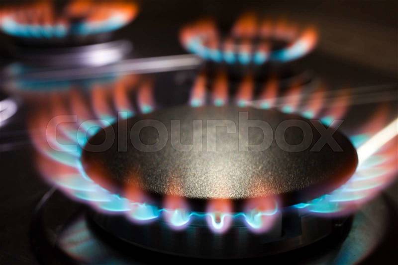 Gas burning in the burner of gas oven, stock photo