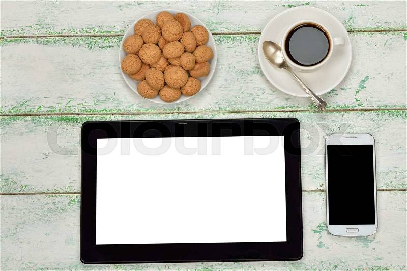 Tablet, smartphone, coffee and biscuits on a white background, stock photo