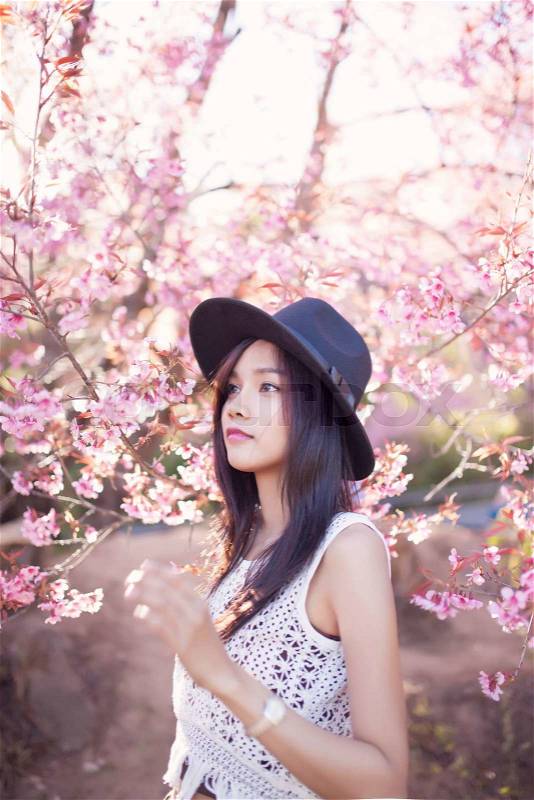Beautiful asian women with sakura flower in thailand, stock photo