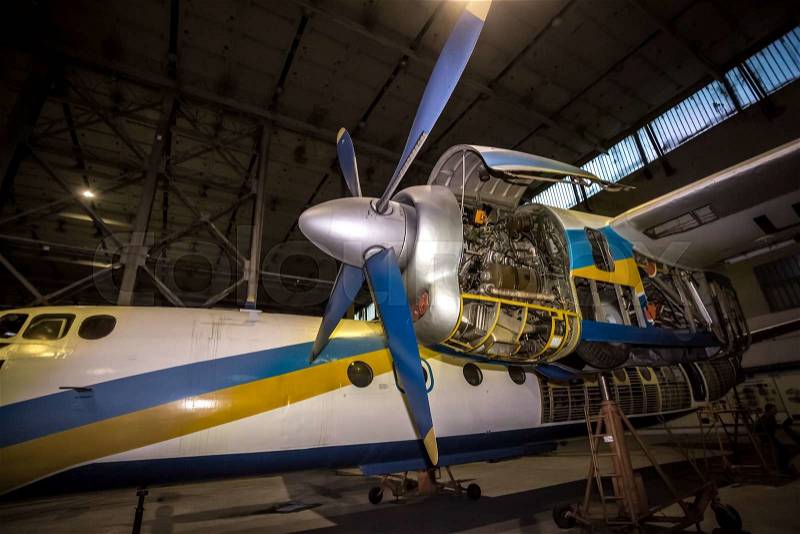 Engine of cargo airplane under maintenance at hangar, stock photo
