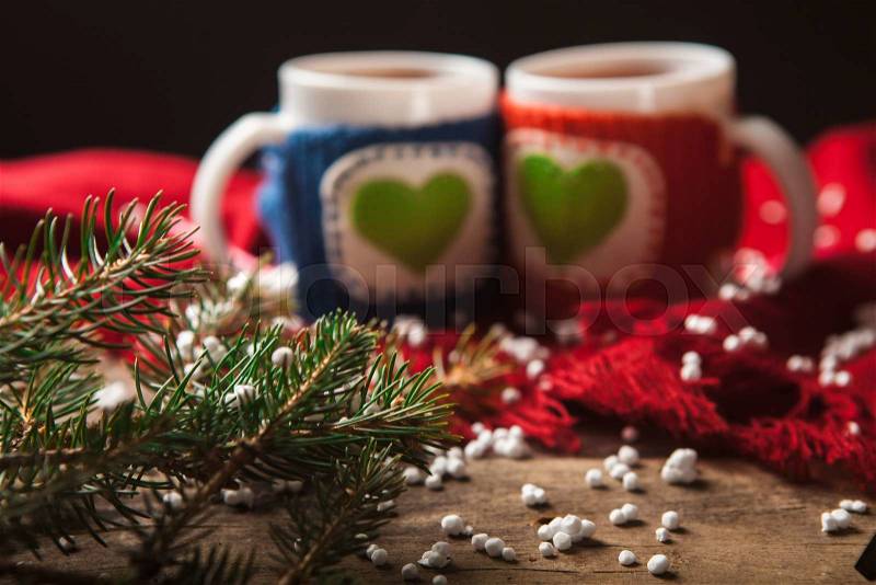 Two warm cups of tea or coffee with red and blue knitted thing on it and with heart for Valentine\'s day, stock photo